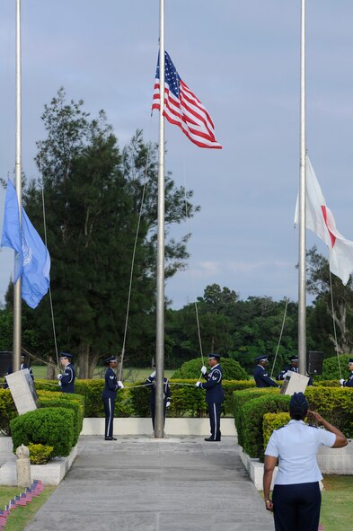 Members of the Kadena Honor Guard hoist the colors during a Memorial Day ceremony on Kadena Air Base, Japan, May 26, 2014. It is a tradition on Memorial Day for the U.S. Flag to be raised to the top of the staff and then lowered to the half-staff position, in remembrance of more than one million men and women who gave their lives in service of their country.