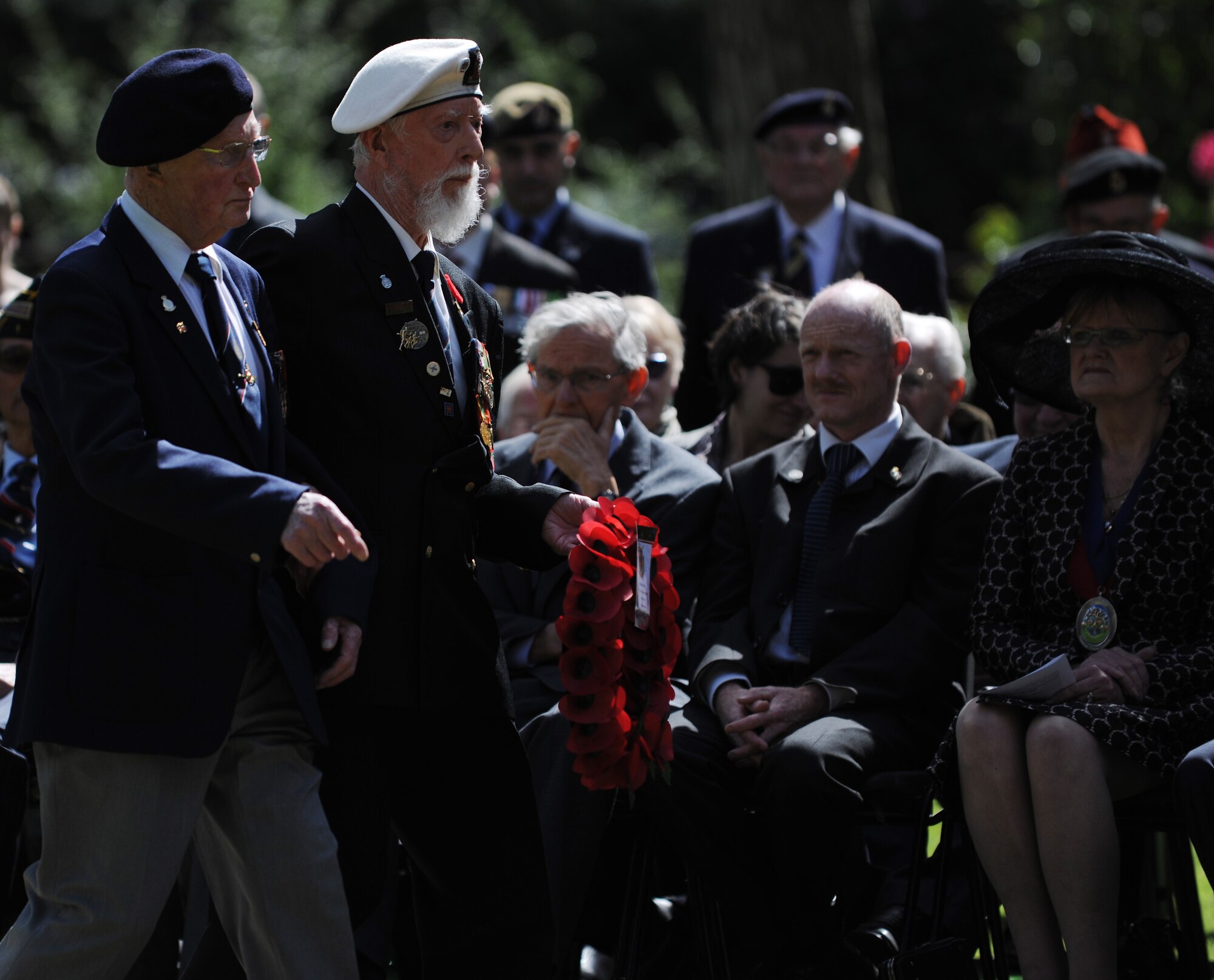 Two World War II veterans and survivors of D-Day walk to place a memorial wreath on the Chapel steps at the Brookwood American Military Cemetery, United Kingdom, May 25, 2014, during a Memorial Day ceremony. This year marks the 70th anniversary of D-Day. (U.S. Air Force photo by Staff Sgt. Jarad A. Denton/Released)