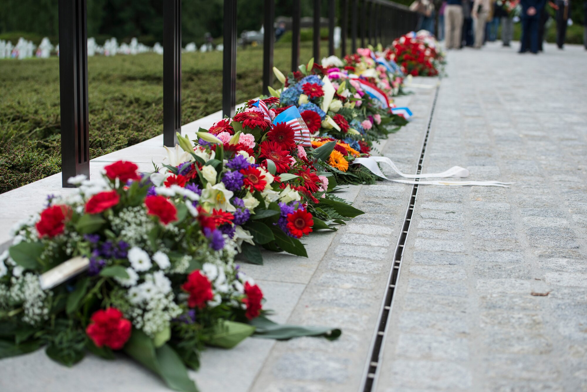 Wreaths are lined up around the fence line during a Memorial Day ceremony at the Luxembourg-American Military Cemetery and Memorial, Luxembourg, May 24, 2014. This year marks the 70th anniversary of the Battle of the Bulge which occurred in World War II. (U.S. Air Force photo by Staff Sgt. Christopher Ruano/Released)