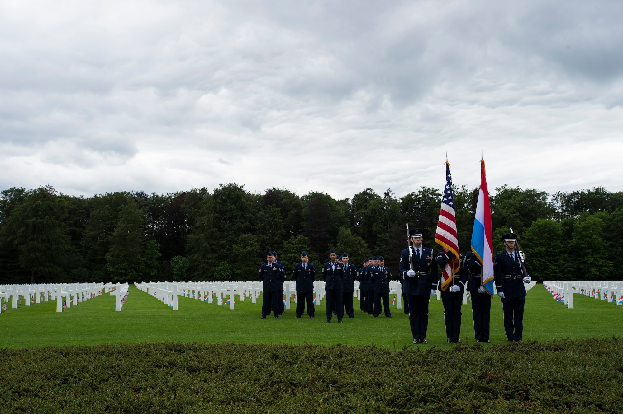 The 52nd Fighter Wing Honor Guard presents the Luxembourg and U.S. flags during a Memorial Day ceremony at the Luxembourg-American Military Cemetery and Memorial, Luxembourg, May 24, 2014. Members of the Luxembourg military were also present to participate in the ceremony and to show their respects. The cemetery is home to more than 5,000 service members who died during World War II. (U.S. Air Force photo by Staff Sgt. Christopher Ruano/Released)