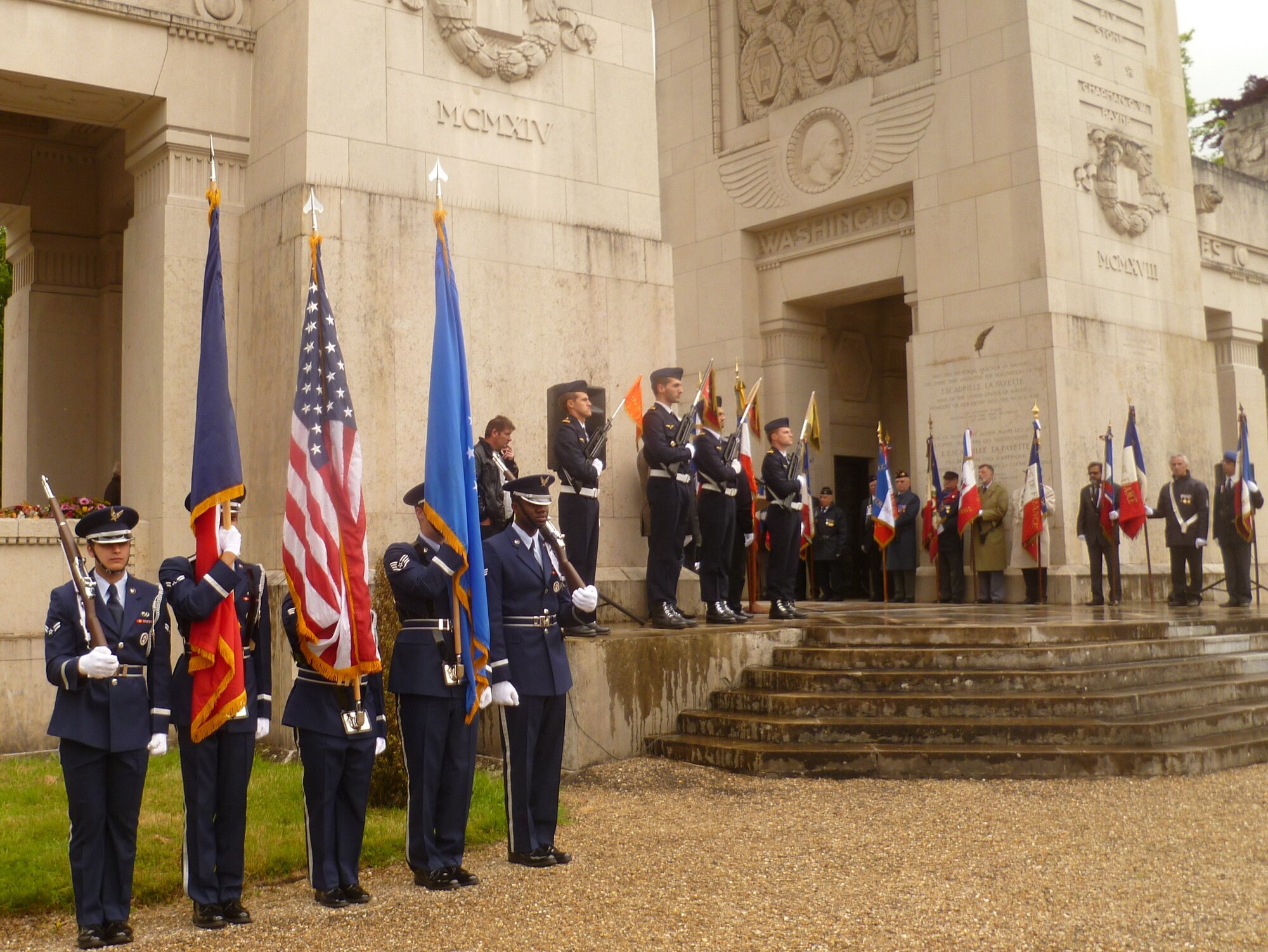 MARNES-LA-COQUETTE, France – Members of the United States Air Forces in Europe and Air Forces Africa Honor Guard present the colors at the Escadrille Lafayette Memorial Service May 24, 2014, just outside Paris. Two hundred French and U.S. civilians and military members gathered together to honor the fallen volunteer pilots of Escadrille Lafayette, or the Lafayette Squadron, who flew combat missions with the French military in WWI before and after the United States officially joined the war. (U.S. Air Force photo/Capt. Reba Good)