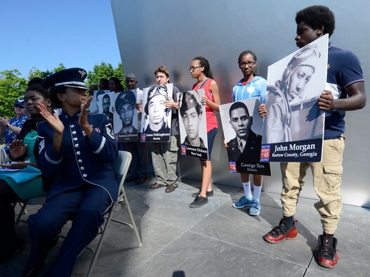 Young volunteers representing the East Coast Chapter of the Tuskegee Airmen Inc. participated in a Memorial Day wreath-laying ceremony held May 26, 2014, at the Air Force Memorial in Arlington, Va. Chief Master Sgt. of the Air Force James A. Cody provided the keynote speech remarking that Memorial Day is a day to remember the freedom that we all share because of the fortitude shown by of our fallen service members in fighting and standing their ground. (U.S. Air Force photo/Jim Varhegyi)