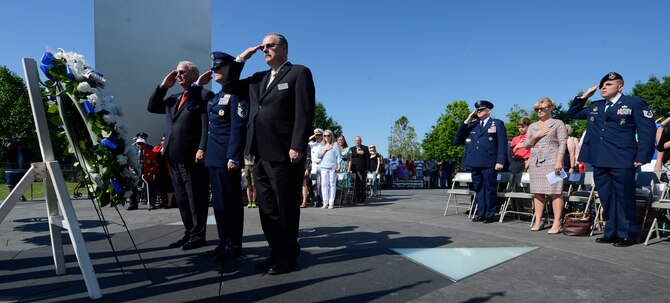 From right, Air Force Sergeant's Association International President retired Chief Master Sgt. Daniel Yeomans, Chief Master Sgt. of the Air Force James A. Cody and Air Force Association President retired Gen. Craig McKinley lay a Memorial Day wreath during a ceremony held May 26, 2014, at the Air Force Memorial in Arlington, Va. Cody provided the keynote speech, remarking that for him, on Memorial Day, the three spires of the memorial stood for freedom, fortitude and our fallen. Cody then told the crowd that today, and everyday, our fallen are with us in our stories and our memories, and they give us cause to wave our flags. (U.S. Air Force photo/Jim Varhegyi)
