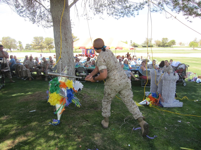 A Marine with 3rd Combat Engineer Battalion strikes a pinata at the unit’s final family day at Desert Winds Golf Course, May 5, 2014. The battalion is slated to deactvate this summer. (Photo by Erika Capistran, FRO)