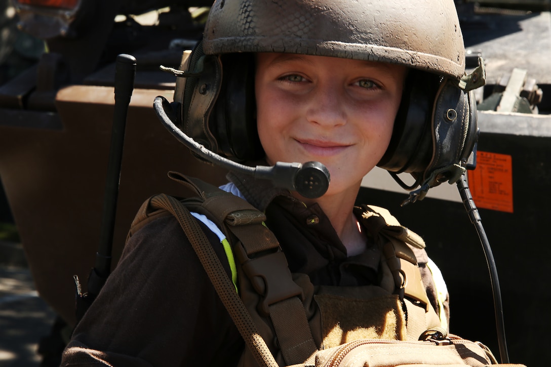 Brydon Jones, 12, tries on the flak and Kevlar of a Marine with 3rd Light Armored Reconnaissance Battalion during the annual Street Fair and Car Show at Luckie Park, May 3, 2014.