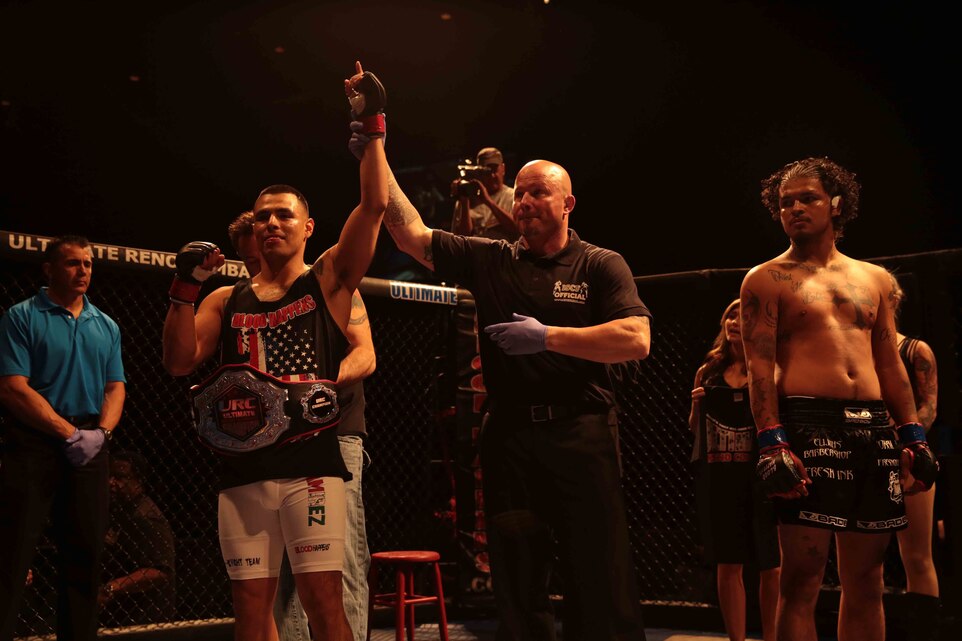Sgt. Daniel Ramirez, clerk, Distribution Management Office, Marine Corps Mountain Warfare Training Center, is announced the winner after defending his welterweight title during an amateur MMA league fight night at the Reno Event Center, May 3, 2014.