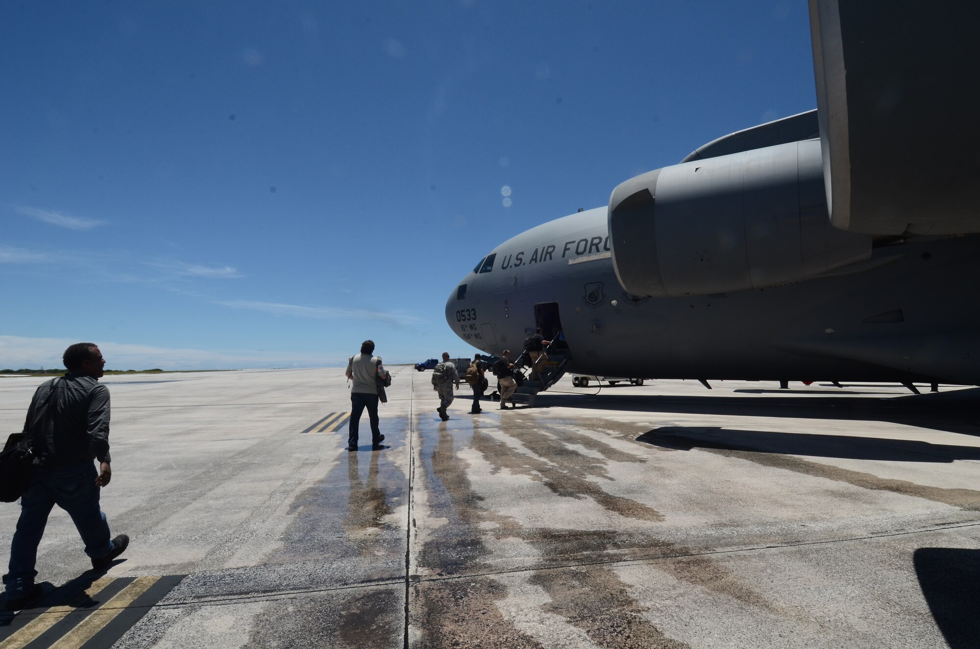 Members of the 69th Reconnaissance Group Detachment 1 board a C-17 Globemaster III to begin their deployment to Misawa Air Base, Japan May 15, 2014, on Andersen Air Force Base, Guam. The detachment is deploying to Misawa to continue providing intelligence, surveillance and reconnaissance support in the Pacific during Guam’s rainy season. (U.S. Air Force photo by Airman 1st Class Emily A. Bradley/Released)