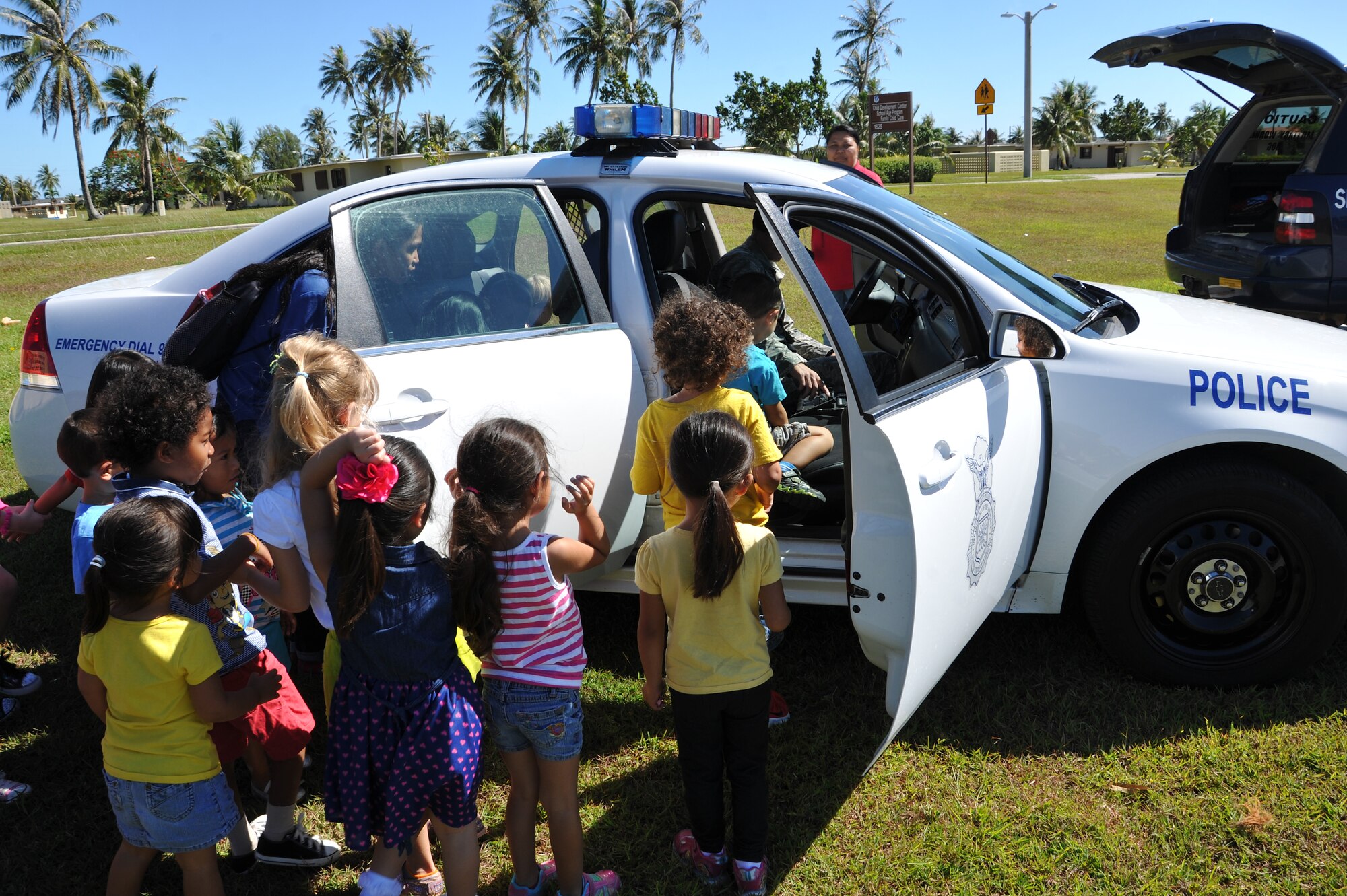 Children from the Andersen Child Development Center explore a police vehicle May 15, 2014, on Andersen Air Force Base, Guam. The 36th Security Forces Squadron demonstrated various types of equipment and skills during the week-long National Police Week event. (U.S. Air Force photo by Senior Airman Cierra Presentado/Released)