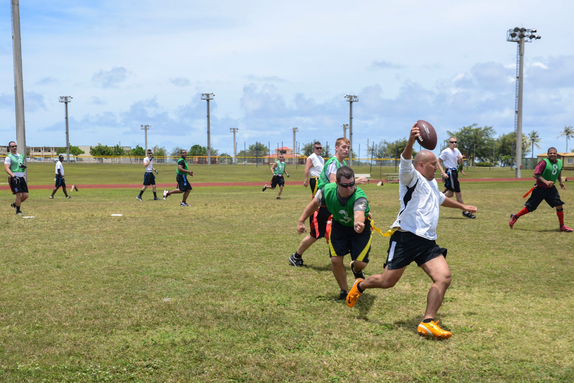 Rich Rollins, 736th Security Forces Squadron, evades a 36th Security Forces Squadron defender during the Battle of the Badges Flag Football Tournament on Andersen Air Force Base, Guam May 13, 2014. The security forces members played an intramural football game as a part of National Police Week along with several other events held that week. (U.S. Air Force photo by Airman 1st Class Adarius Petty/Released)