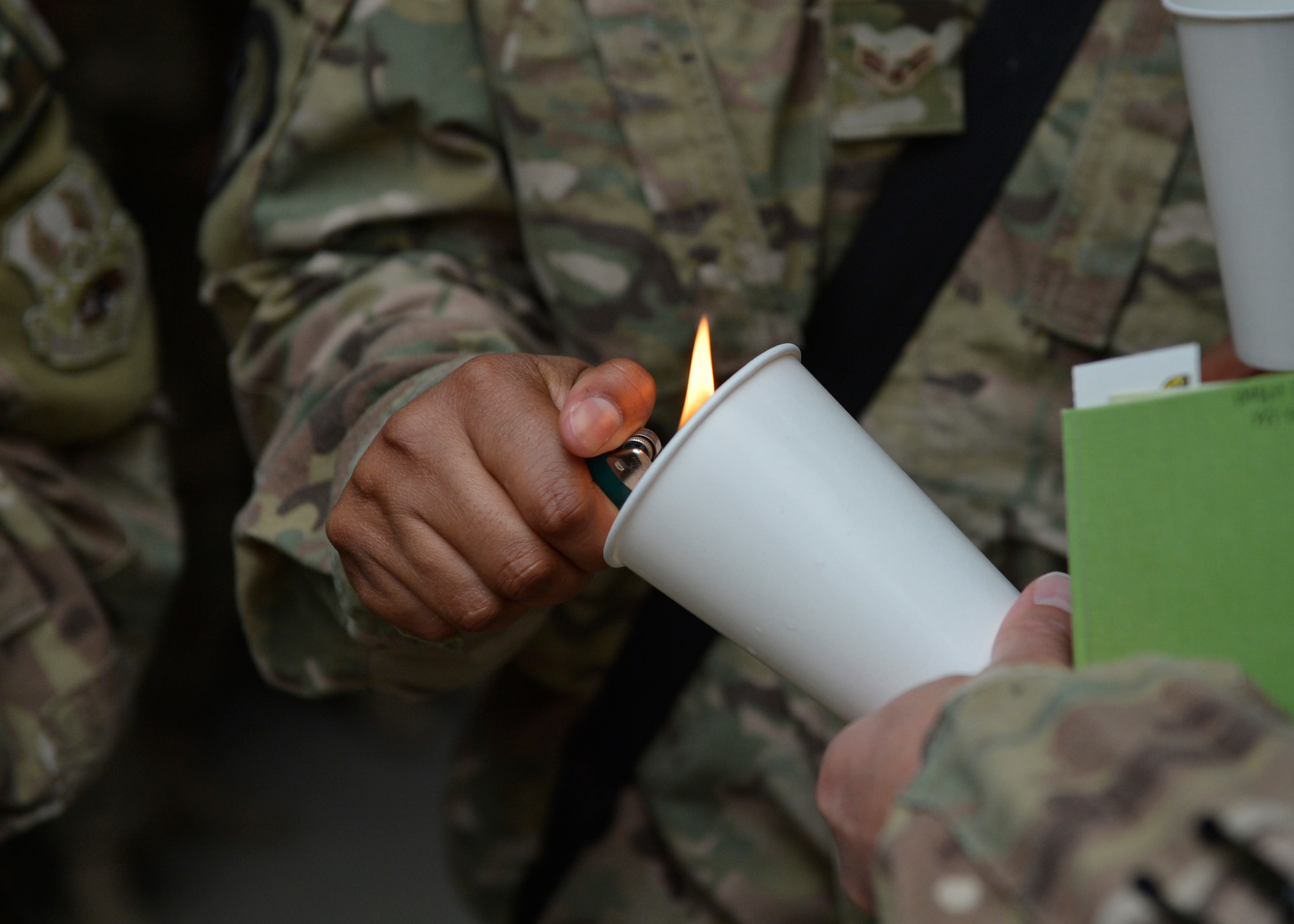 U.S. Air Force Airmen light a candle during a Memorial Day candle vigil May 26, 2014 at Bagram Airfield, Afghanistan.  Memorial Day is observed annually on the last Monday of May to commemorate the men and women who died while serving in the U.S. Armed Forces. (U.S. Air Force photo by Staff Sgt. Evelyn Chavez/Released)