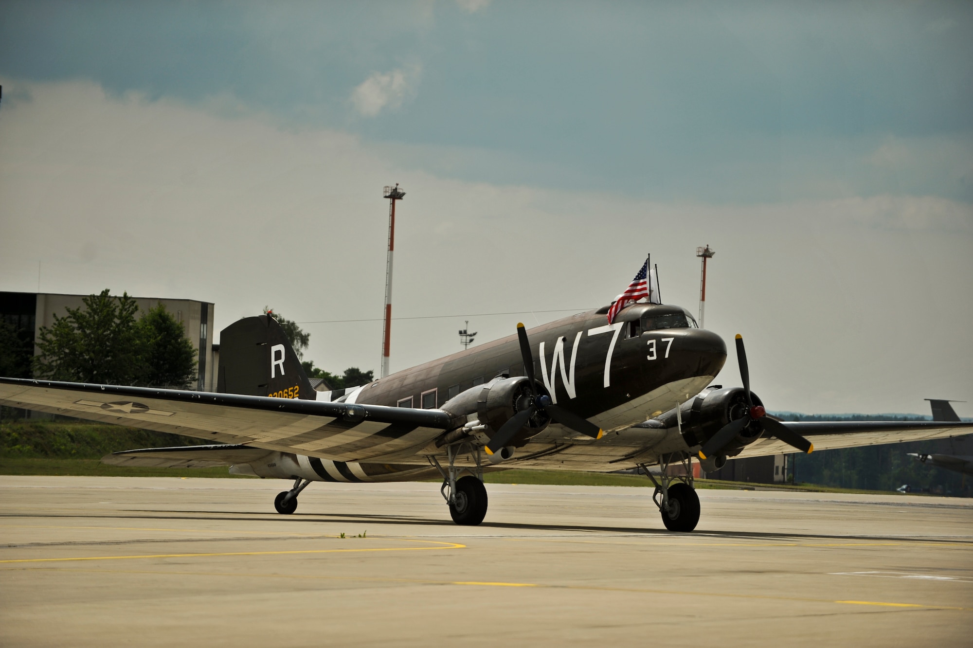 A Douglas C-47 Skytrain troop carrier aircraft, designated Whiskey 7, lands at Ramstein Air Base, May 26, 2014. Whiskey 7 was the lead carrier of 37th Troop Carrier Squadron that took part in dropping the 82nd Airborne Division near St. Mere Eglise, France during D-Day, June 6th, 1944. The historical aircraft landed at Ramstein before heading to Normandy to take part in commemoration events for the 70th Anniversary of D-Day. (U.S. Air Force photo/Staff Sgt. Sara Keller)