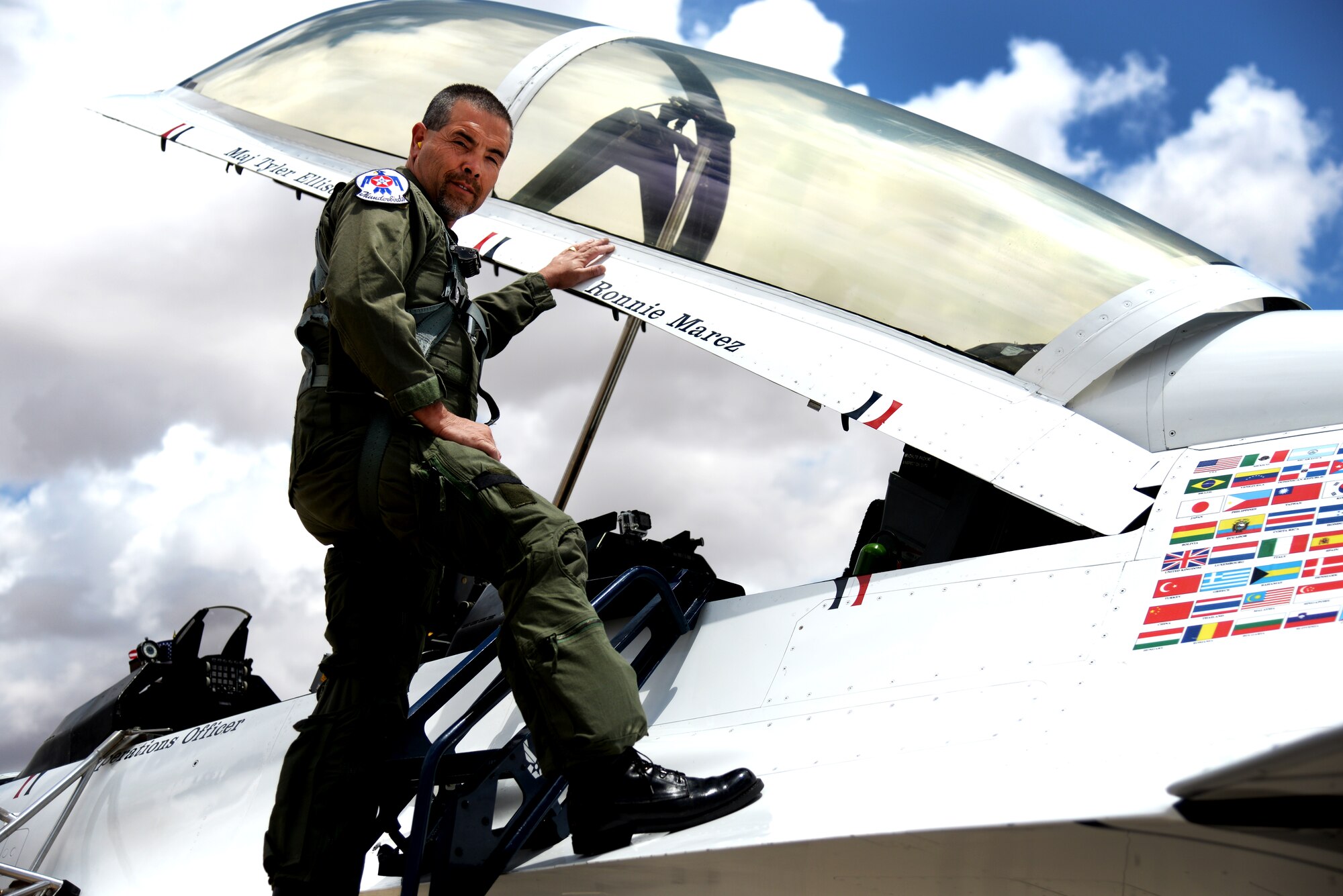 Placing his hand hear his name, Ronnie Marez prepares to board Thunderbird 7. Marez was selected by the Thunderbirds for a once-in-a-lifetime flight for his record of service in the community. (U.S. Air Force Photo/Airman 1st Class Chip Slack)