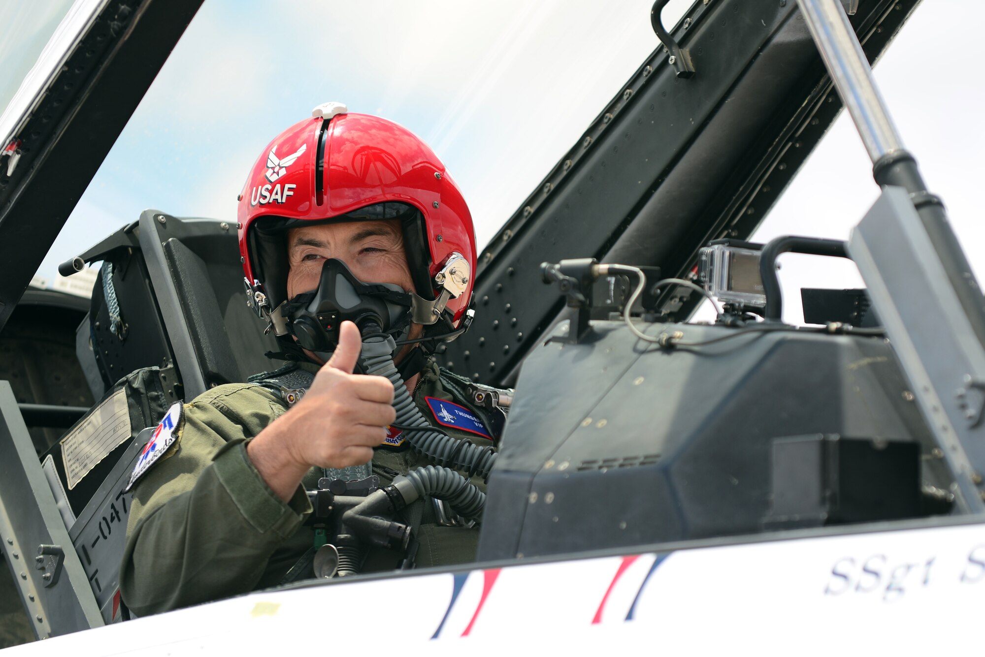 Ronnie Marez, the hometown hero selected by the Thunderbirds for a once-in-a-lifetime flight in an F-16C, flashes a thumbs-up to his family before takeoff. Marez endured more than seven Gs and flew at speeds in excess of 500 miles per hour. (U.S. Air Force Photo/Airman 1st Class Shelby Kay-Fantozzi)