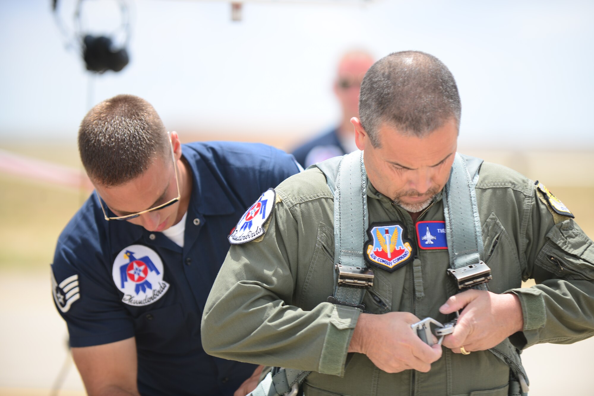 Ronnie Marez, the hometown hero selected by the Thunderbirds for a once-in-a-lifetime flight in an F-16C, straps into his G-suit before his flight. Marez was selected for the honor after rendering aid to an elderly woman in the local area. (U.S. Air Force Photo/Airman 1st Class Shelby Kay-Fantozzi)