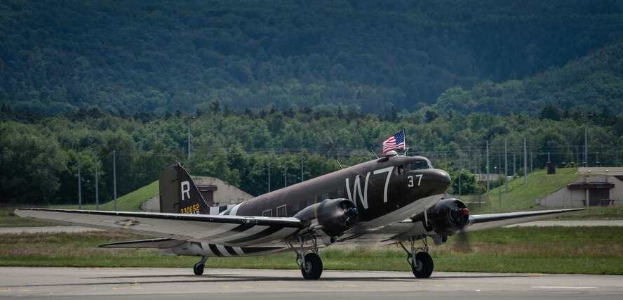 A Douglas C-47 Skytrain troop carrier aircraft, designated Whiskey 7, lands on Ramstein Air Base, May 26, 2014. Whiskey 7 was the lead carrier of 37th Troop Carrier Squadron that took part in dropping the 82nd Airborne Division near St. Mere Eglise, France during D-Day, June 6th, 1944. The historical aircraft landed on Ramstein before heading to Normandy to take part in commemoration events for the 70th Anniversary of D-Day. (U.S. Air Force photo/Airman 1st Class Jordan Castelan)