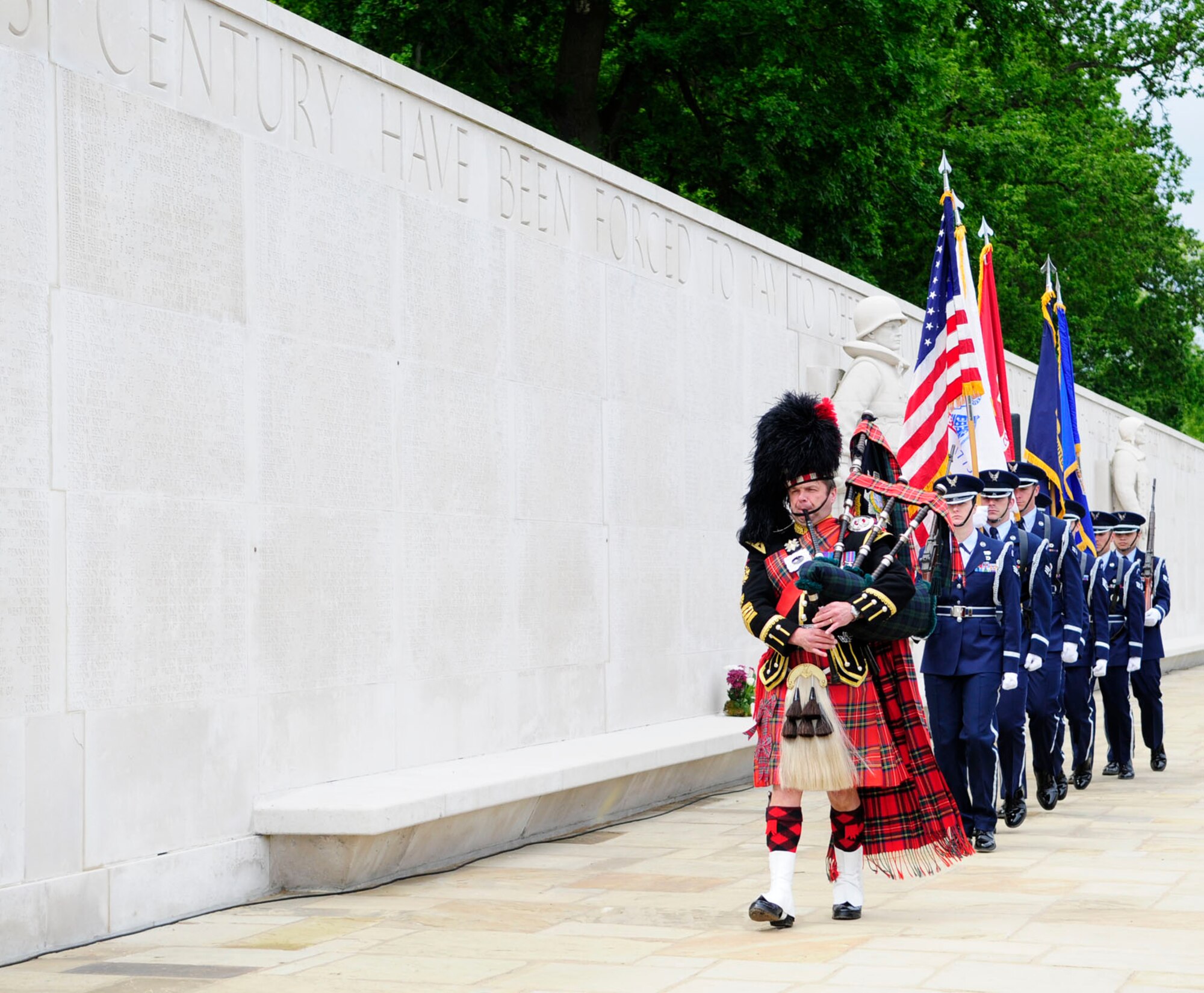 A traditional Scottish bagpiper leads the RAF Mildenhall Honor Guard as they post the colors May 26, 2014, at the Madingley American Cemetery in Cambridge, England. Memorial Day originated after the American Civil War and is recognized annually in memoriam of the fallen. (U.S. Air Force photo by Karen Abeyasekere/Released)