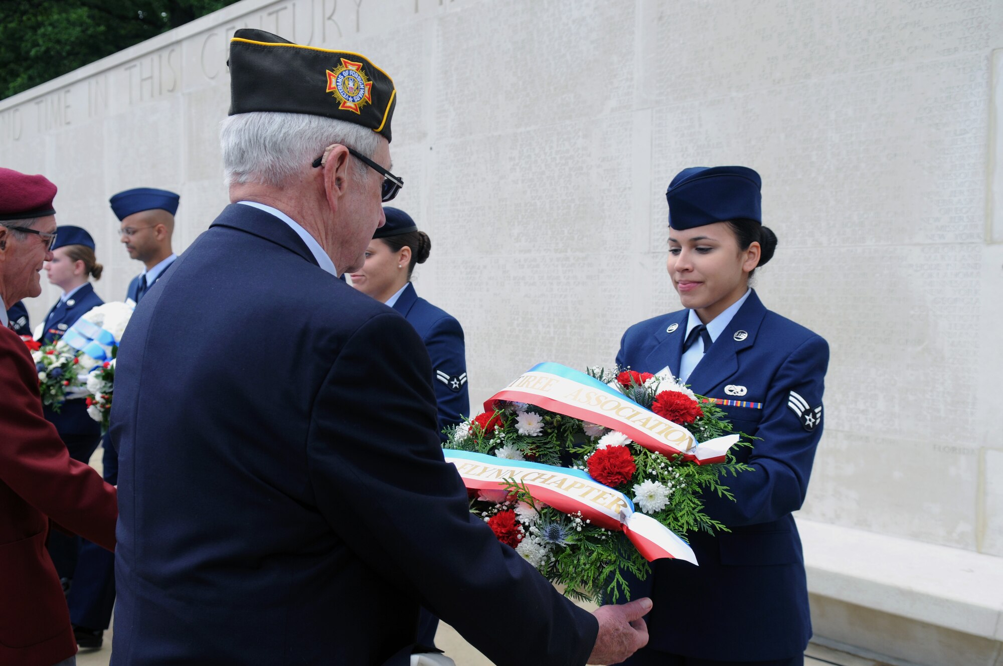 U.S. Air Force Airmen present wreaths during a Memorial Day ceremony May 26, 2014, at the Madingley American Cemetery in Cambridge, England. The wreaths are given in remembrance of service members who died during World War II.  (U.S. Air Force photo by Airman 1st Class Kyla Gifford/Released)