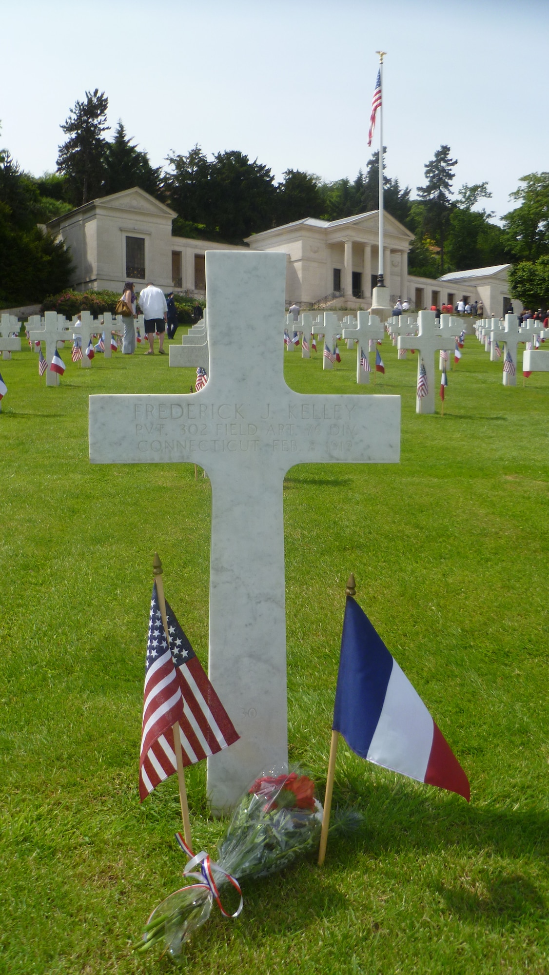 SURESNES, France – Two hundred French and U.S. service members and civilians gathered at Suresnes Cemetery, just outside Paris May 25, 2014, to honor fallen Americans who fought and died during the two world wars. After the ceremony, children distributed flowers for attendees to place on graves. This grave is the resting place of Pvt. Frederick J. Kelley from Connecticut, who served in the 302nd Field Artillery 76th Division. He died Feb. 8, 1919, four months before the Treaty of Versailles officially ended WWI. (U.S. Air Force photo/Capt. Reba Good)