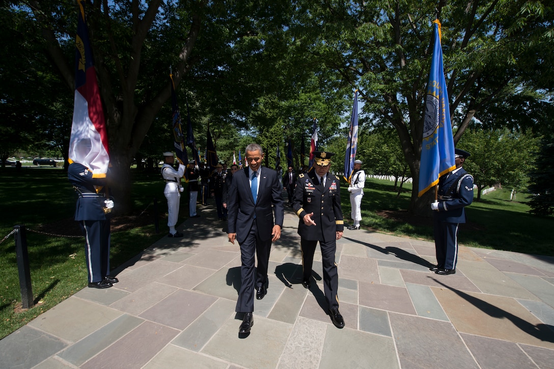 President Barack Obama walks through an honor cordon during a Memorial ...