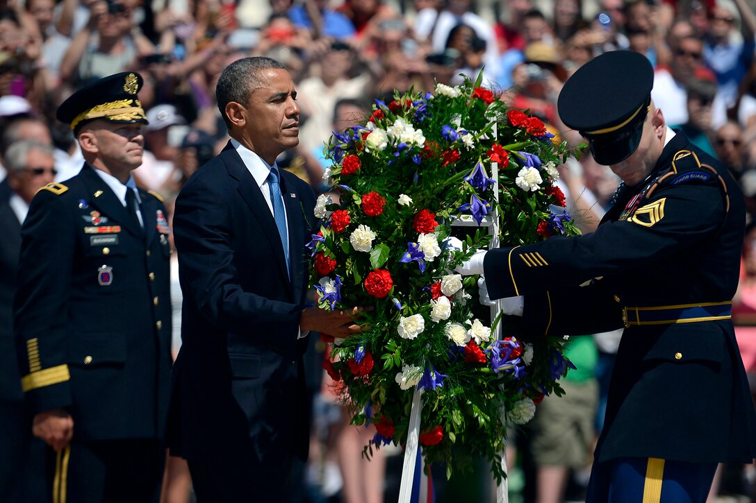 President Barack Obama lays a wreath during a Memorial Day ceremony at Arlington National Cemetery, Va., May 26, 2014.