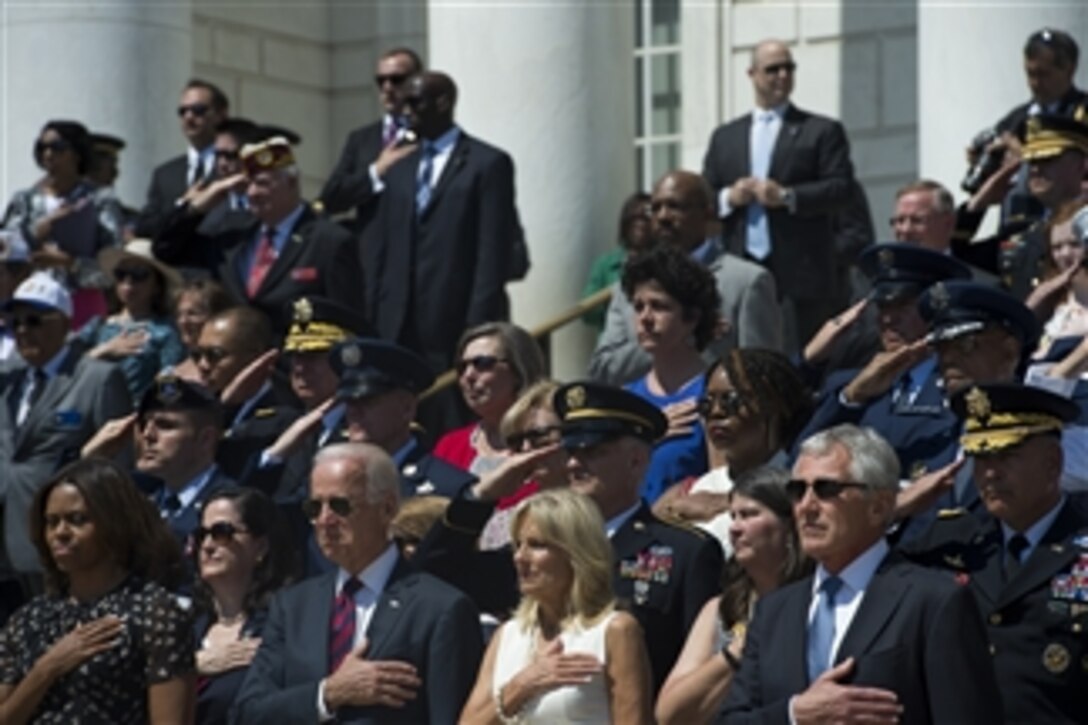 Defense Secretary Chuck Hagel, right, First Lady Michelle Obama, left, Vice President Joe Biden, and his wife, Dr. Jill Biden, render honors as the national anthem plays during a Memorial Day ceremony at Arlington National Cemetery in Arlington, Va., May 26, 2014.