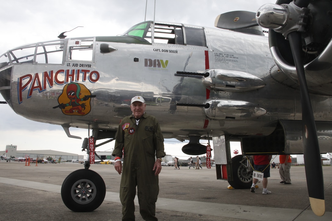 Retired Brig. Gen. George Bartlett, a former navigator bombardier during WWII, stands near a B-25 Mitchell bomber May 18 during the 2014 Marine Corps Air Station Cherry Point Air Show. Bartlett flew out of Cherry Point 70 years ago in a North American Aviation patrol bomber, a naval version of the B-25, for combat in the South Pacific. While there, he flew 75 combat missions. His return flight to the air station for the air show marked a significant milestone not just in aviation history, but in the passing of the torch from an older generation to a new one, said the 90-year-old aviator.