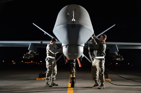 Airman 1st Class Steven and Airman 1st Class Taylor prepare an MQ-9 Reaper for flight during Combat Hammer May 15, 2014,  at Creech Air Force Base, Nev. Fighter, bomber and remotely piloted aircraft units around the Air Force are evaluated four times a year and provided weapons, airspace and targets from Hill AFB, Utah, or Eglin AFB, Fla. Steven and Taylor are MQ-9 crew chiefs with the 432nd Aircraft Maintenance Squadron.  (U.S. Air Force photo/Staff Sgt. N.B.)  