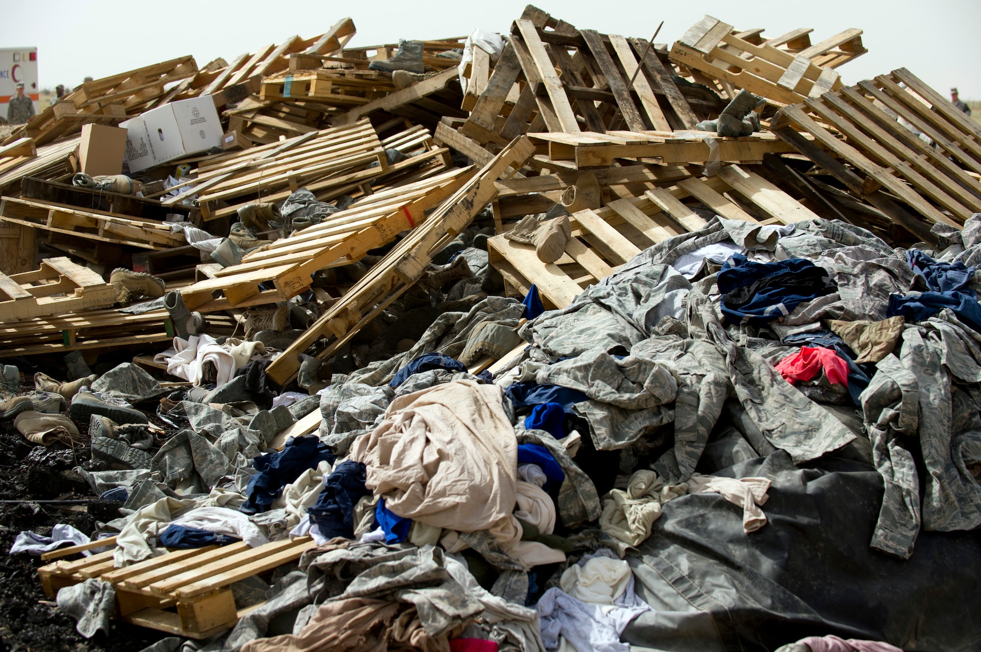 A pile of unserviceable uniforms items await destruction during a training burn by the 386th Expeditionary Civil Engineer Squadron Fire Department April 18, 2014, in Southwest Asia.  The uniforms were collected over the course of a year and were destroyed to ensure they do not end up being utilized improperly if discarded with normal trash.  (U.S. Air Force photo/Senior Master Sgt. Burke Baker) 