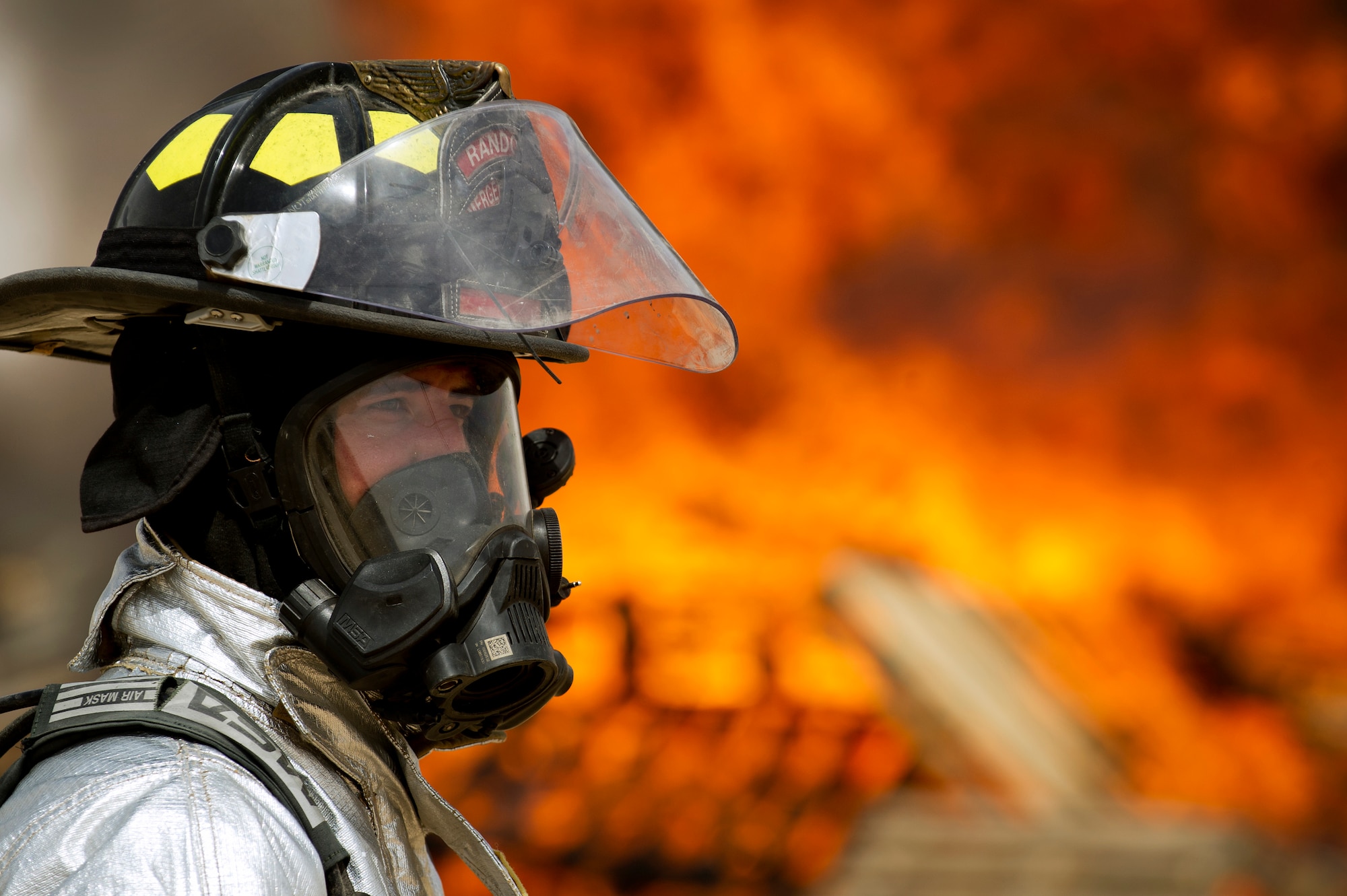 Senior Airman Brett Olsen monitors a training fire used to destroy a pile of unserviceable uniforms items April 18, 2014, in Southwest Asia.  The uniforms were collected over the course of a year and were destroyed to ensure they do not end up being utilized improperly if discarded with normal trash.  Olsen is a firefighter with the 386th Expeditionary Civil Engineer Squadron. (U.S. Air Force photo by Senior Master Sgt. Burke Baker)