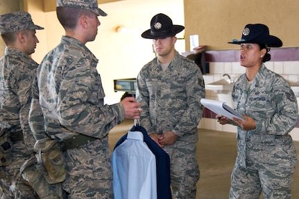 Air Force Staff Sgt. Maria Escobar, a military training instructor with the 737th Training Group, goes over uniform items with trainees during basic military training at Joint Base San Antonio-Lackland, Texas, May 20, 2014. Escobar, a member of the Massachusetts Air National Guard, volunteered for MTI duty to teach and mentor future Airmen. Air Guard members can apply for MTI duty and after fulfilling their four year assignment, return to their home units. 