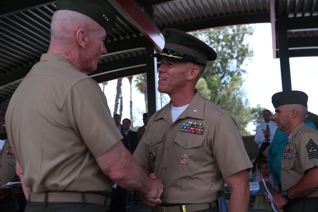 Lieutenant Col. Jan R. Durham, former commanding officer, 1st Law Enforcement Battalion, greets Lt. Gen. John A. Toolan, commanding general, I Marine Expeditionary Force after a change of command ceremony aboard Marine Corps Base Camp Pendleton, Calif., May 23, 2014. During the ceremony, Durham relinquished command of 1st LEB to Lt. Col. Daron M. Mizell.