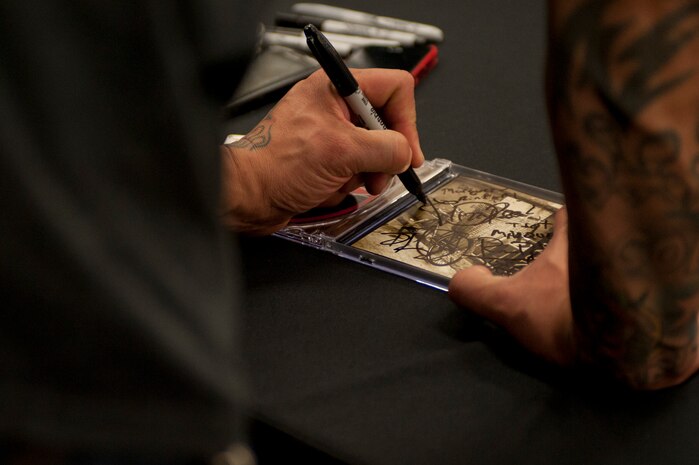 Frank Ferrer, Guns N' Roses drummer, signs an autograph during a band meet and greet May 27, 2014, at the Exchange on Nellis Air Force Base, Nev. Ferrer became an official member of the band in October 2006. (U.S. Air Force photo by Senior Airman Timothy Young)