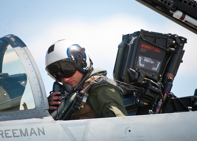 U.S. Navy Lt. Jon Hill, naval aviator assigned to Strike Fighter Squadron 131, Naval Air Station Oceana, Va. performs pre-flight checks on an F/A-18C Hornet prior to Green Flag 14-07, May 21, 2014, at Nellis Air Force Base, Nev. Green Flag is a realistic air-land integrated combat training exercise involving the different branches of the U.S. military and its allies. Green Flag exercises provide critical joint training for approximately 75,000 joint and coalition military members per year. (U.S. Air Force photo by Airman 1st Class Thomas Spangler)