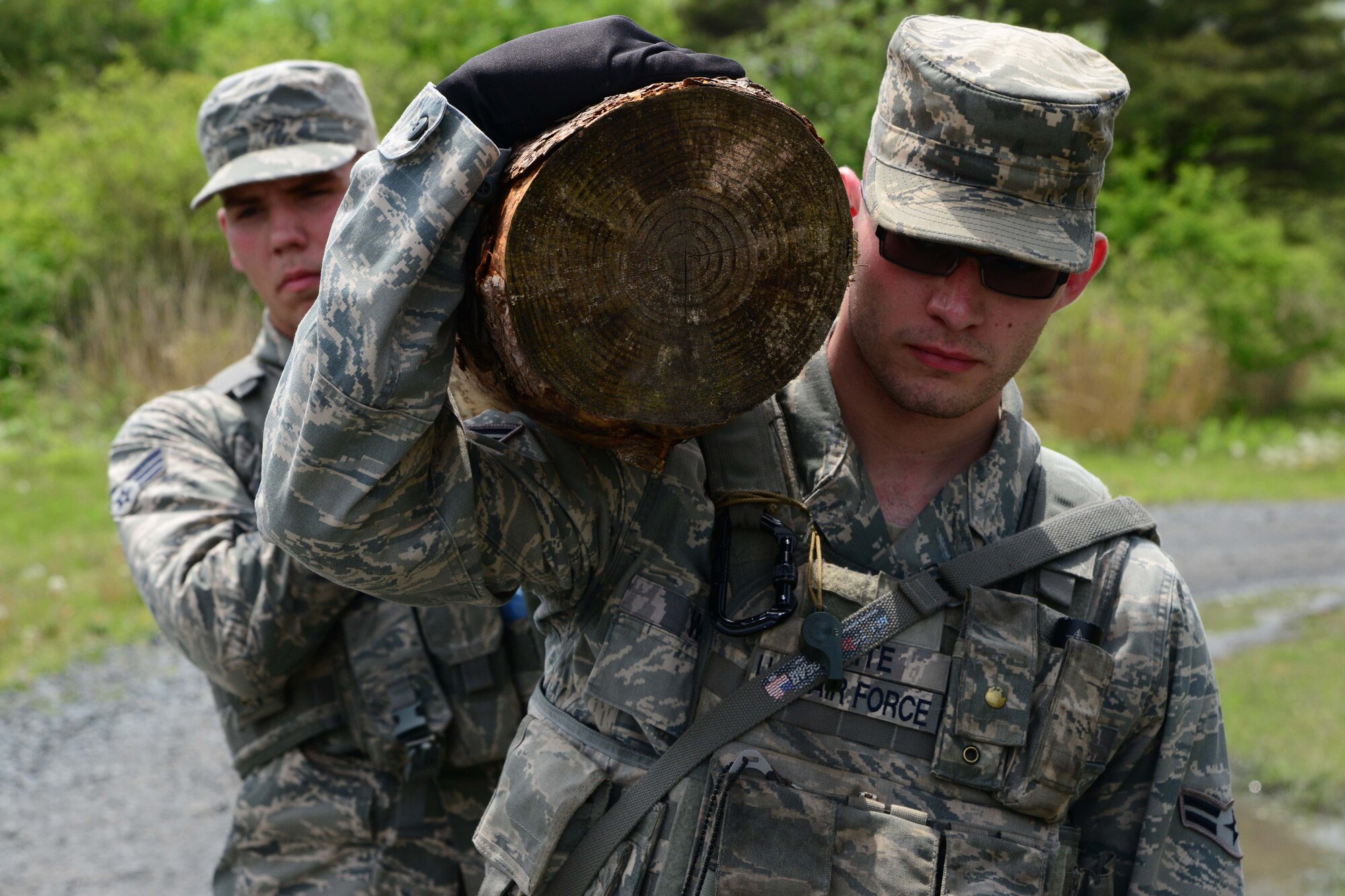 U.S. Air Force Senior Airman Craig Fry, left, and Airman 1st Class Matthew White, 35th Security Forces Squadron, carry a log during a mile-long ruck march at Misawa Air Base, Japan, May 27, 2014. The march was part of a tryout day for the 35 SFS Special Reaction Team. The squadron’s SRT is the 35th Fighter Wing’s frontline response team for special emergencies and high-risk sutiations. (U.S. Air Force photo/Senior Airman Derek VanHorn)