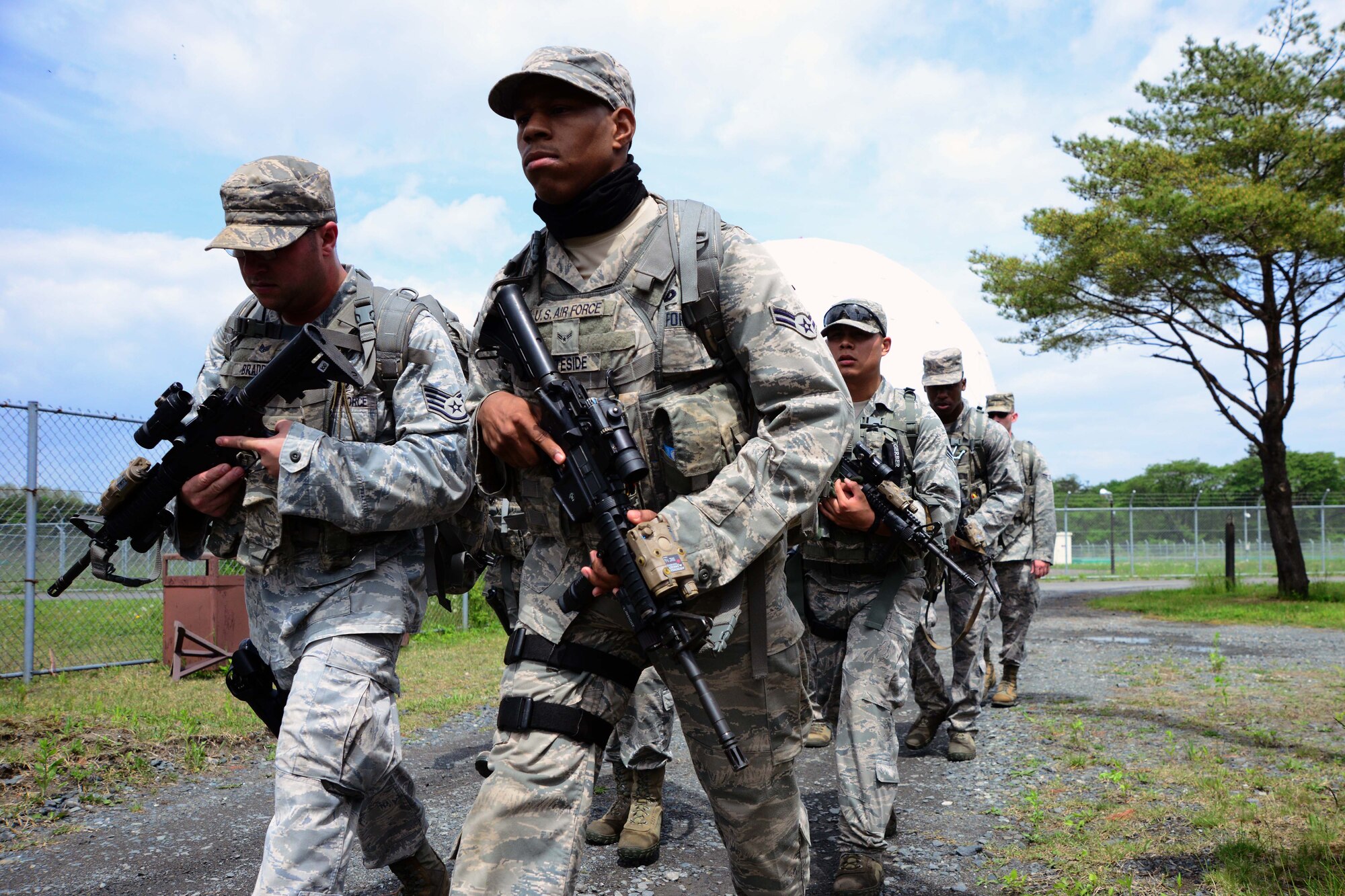 U.S. Air Force Staff Sgt. Doyle Braddy, left, 35th Security Forces Squadron, and Airman 1st Class Juron Whiteside, 35 SFS, lead a Special Reaction Team during a ruck march around the north side of Misawa Air Base, Japan, May 27, 2014. The SRT was returning to base camp after executing buddy carries during a day-long training session that covered various techniques and procedures. (U.S. Air Force photo/Senior Airman Derek VanHorn)