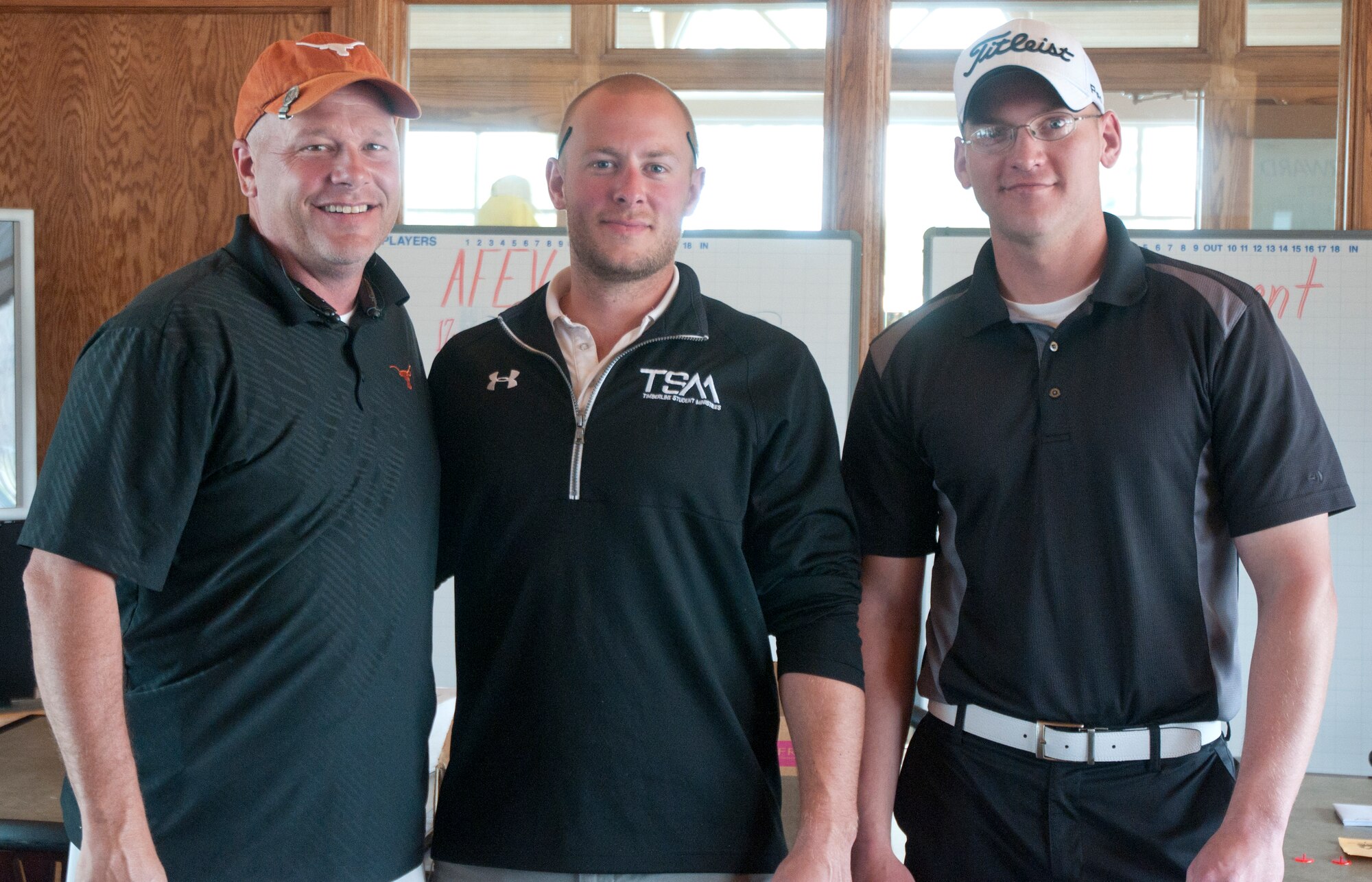 Master Sgt. Bradley Grimmett, 90th Force Support Squadron, left, Joe Strother, human resources director for American Family Benefits Association, center, and William Sweeney, 90th Comptroller Squadron, right, pose after winning the Air Force Enlisted Village golf tournament. The team finished at 17 below the course par of 72. (U.S. Air Force photo by Airman Malcolm Mayfield)