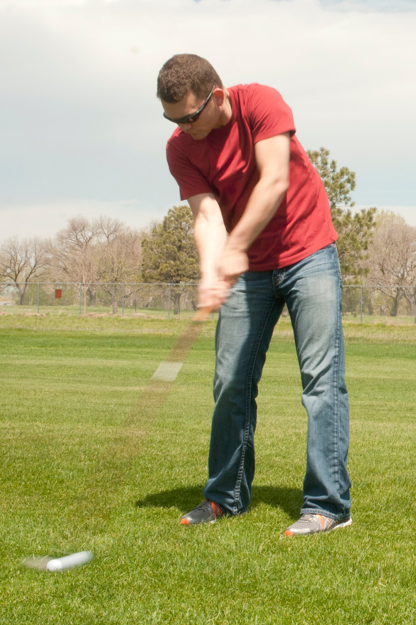 Senior Airman David Jung, 90th Missile Maintenance Squadron, hits a golf ball during the Air Force Enlisted Village golf tournament May 22 at the Warren Golf Course. The tournament was used as a fundraiser to gather money for the Air Force Enlisted Village. The golf tournament raised a total of $2,900. (U.S. Air Force photo by Airman Malcolm Mayfield)