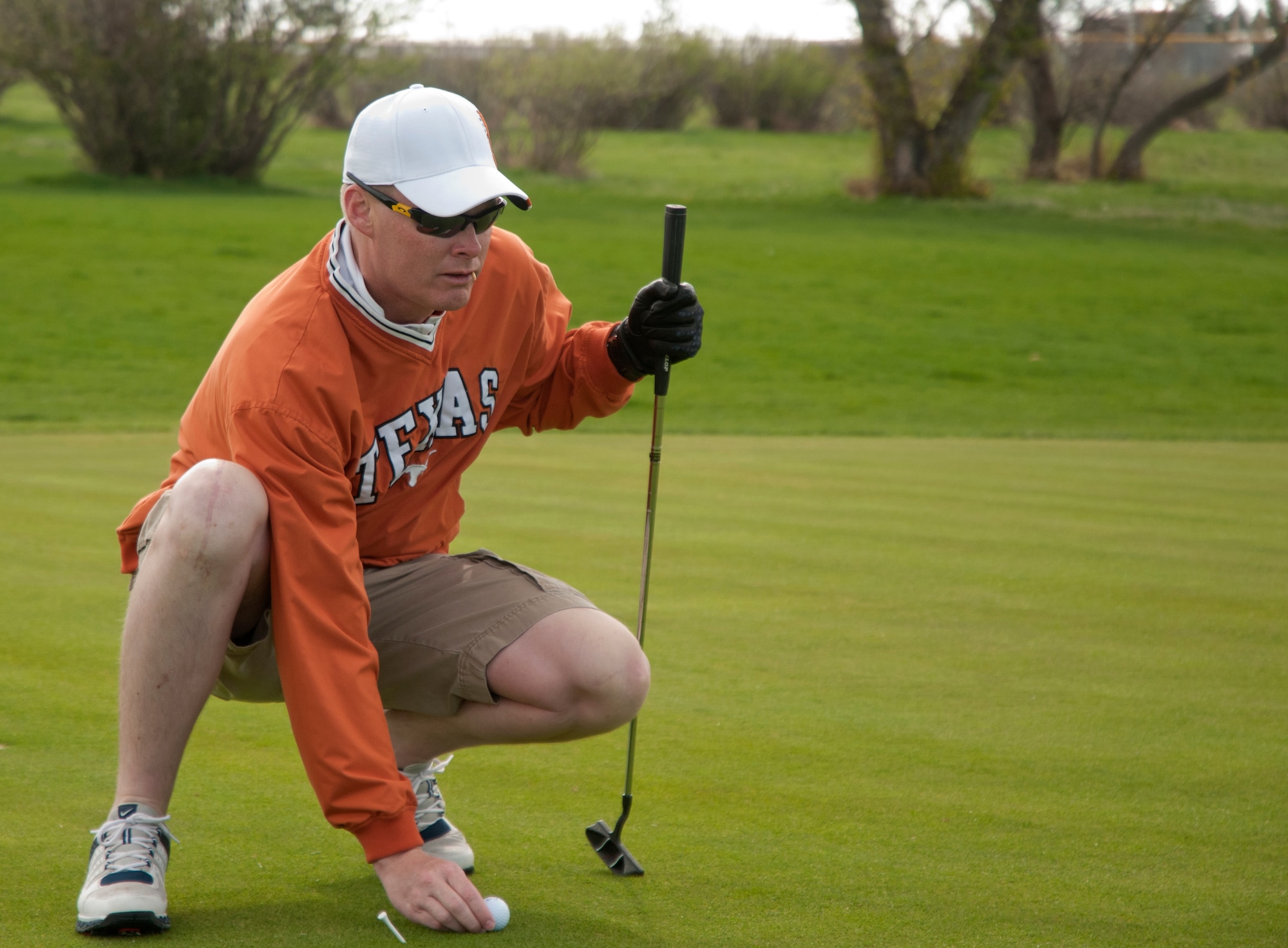 Master Sgt. Patrick Alberts, 90th Security Support Squadron, lines up a putt during the Air Force Enlisted Village golf tournament May 22 at the Warren Golf Course. The tournament consisted of 10 teams with a maximum of four players on each team. (U.S. Air Force photo by Airman Malcolm Mayfield)