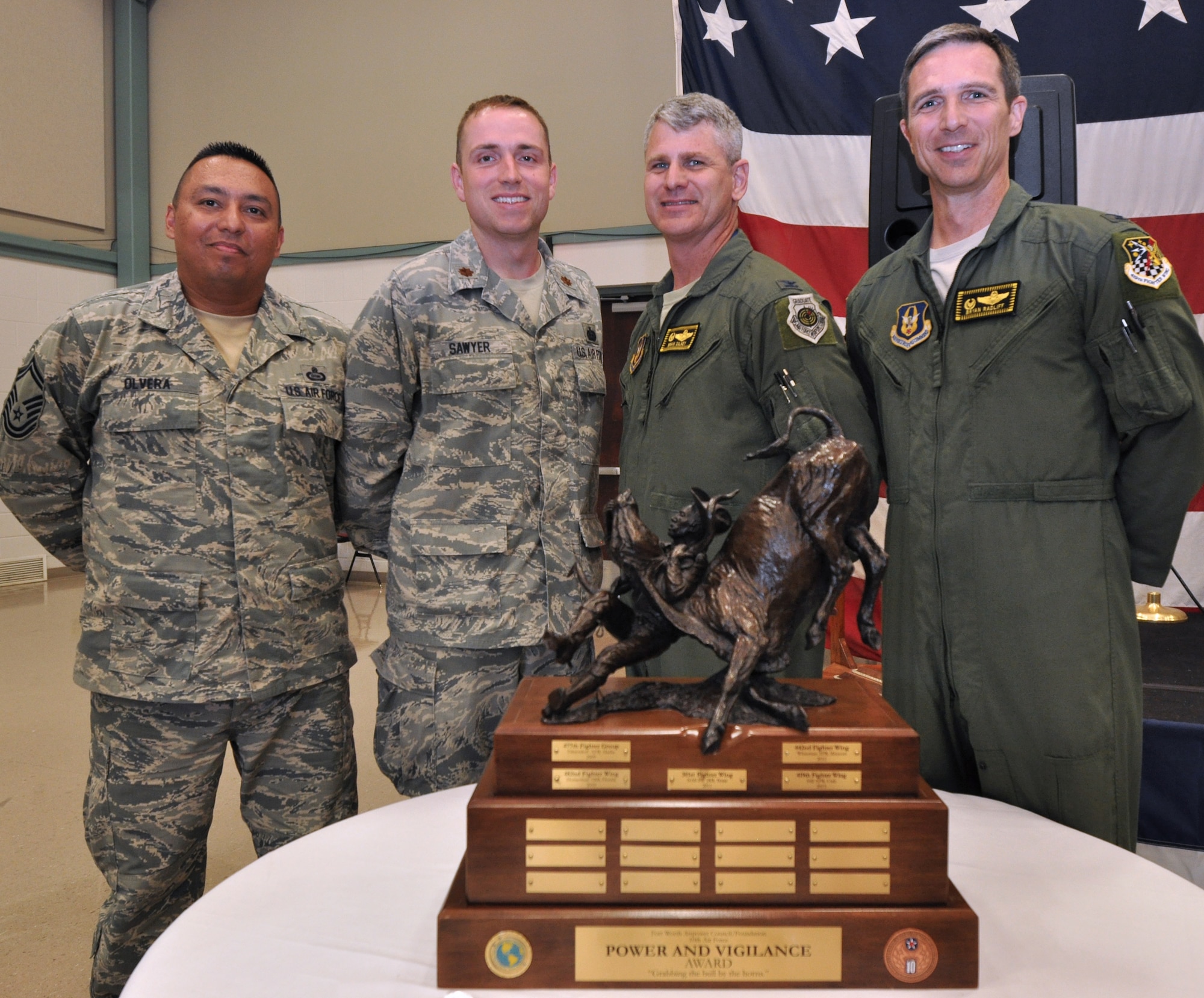 As the latest recipients of the 10th Air Force Power and Vigilance award, members of the 419th Fighter Wing pose with the trophy. The 419th Fighter Wing at Hill Air Force Base, Utah, was recently proclaimed the premier unit within 10th Air Force, winning trophy bragging rights for the year. The Power and Vigilance Award is presented annually to the 10 AF Reserve unit that exhibits the NAF mission as "the premier provider of affordable, integrated, flexible, and mission-ready Citizen Airmen to execute power and vigilance missions in support of U.S. National Security.” The symbolism of the bronze figure on the award says it all, ‘grabbing the bull by the horns’.  They are only the fifth unit to hold this honor. (U.S. Air Force photo/Master Sgt. Julie Briden-Garcia)