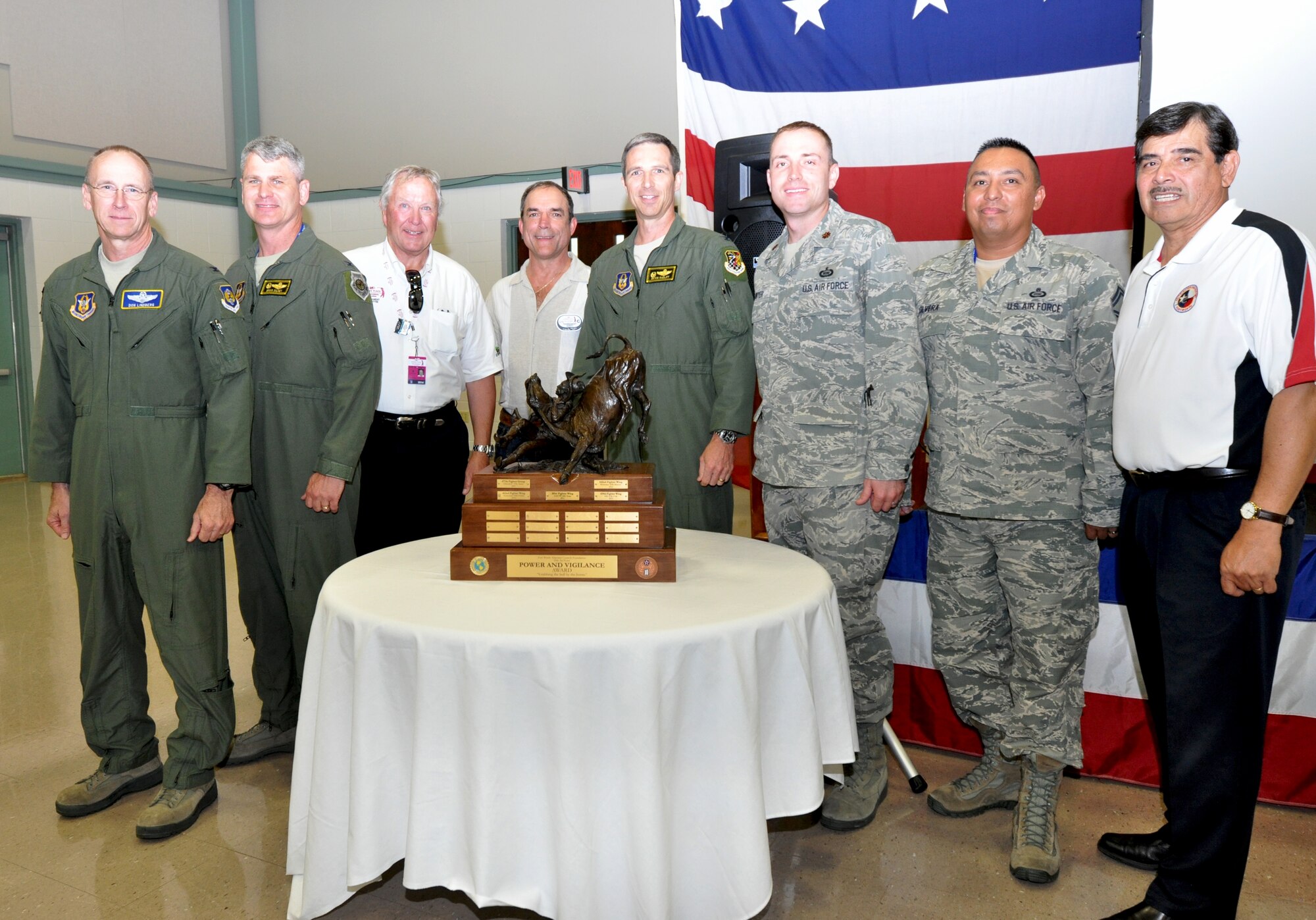 Colonel Donald Lindberg, 10th Air Force vice commander,  members of the 419th Fighter Wing and Airpower Foundation chairman, Roman Palomares, pose with the Power and Vigilance trophy. The 419th Fighter Wing at Hill Air Force Base, Utah, was recently proclaimed the premier unit within 10th Air Force, winning trophy bragging rights for the year. The Power and Vigilance Award is presented annually to the 10 AF Reserve unit that exhibits the NAF mission as "the premier provider of affordable, integrated, flexible, and mission-ready Citizen Airmen to execute power and vigilance missions in support of U.S. National Security.” The symbolism of the bronze figure on the award says it all, ‘grabbing the bull by the horns’.  They are only the fifth unit to hold this honor. (U.S. Air Force photo/Master Sgt. Julie Briden-Garcia)
