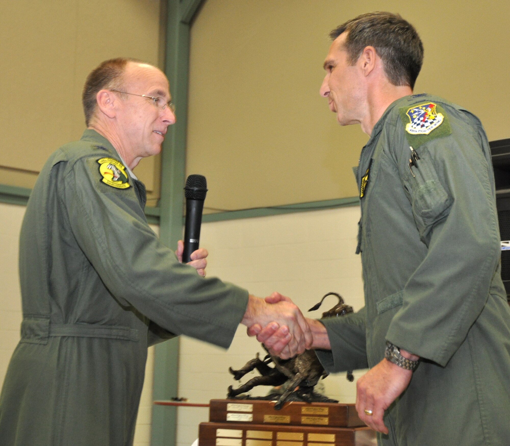 Col. Donald Lindberg, 10th Air Force vice commander, congratulates this year's winner of the 10th Air Force Power and Vigilance trophy, Col. Bryan Radliff, 419th Fighter Wing commander. This is only the fifth year this trophy has found a home. The first four winners being the 477th Fighter Group, Elmendorf, Alaska, 482nd Fighter Wing, Homestead ARB, Fla., 301st Fighter Wing, NAS Fort Worth JRB, Texas, and the 442nd Fighter Wing, Whiteman AFB, Missouri. The Power and Vigilance Award is presented annually to the 10 AF Reserve unit that exhibits the NAF mission as "the premier provider of affordable, integrated, flexible, and mission-ready Citizen Airmen to execute power and vigilance missions in support of U.S. National Security.” The symbolism of the bronze figure on the award says it all, ‘grabbing the bull by the horns’. (U.S. Air Force photo/Master Sgt. Julie Briden-Garcia) 