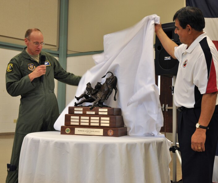 Colonel Donald Lindberg, 10th Air Force vice commander, unveils the latest addition to the Power and Vigilance trophy with Roman Palomares, Airpower Foundation chairman. The 419th Fighter Wing at Hill Air Force Base, Utah, was recently proclaimed the premier unit within 10th Air Force, winning trophy bragging rights for the year. The Power and Vigilance Award is presented annually to the 10 AF Reserve unit that exhibits the NAF mission as "the premier provider of affordable, integrated, flexible, and mission-ready Citizen Airmen to execute power and vigilance missions in support of U.S. National Security.” The symbolism of the bronze figure on the award says it all, ‘grabbing the bull by the horns’.  They are only the fifth unit to hold this honor. (U.S. Air Force photo/Master Sgt. Julie Briden-Garcia)