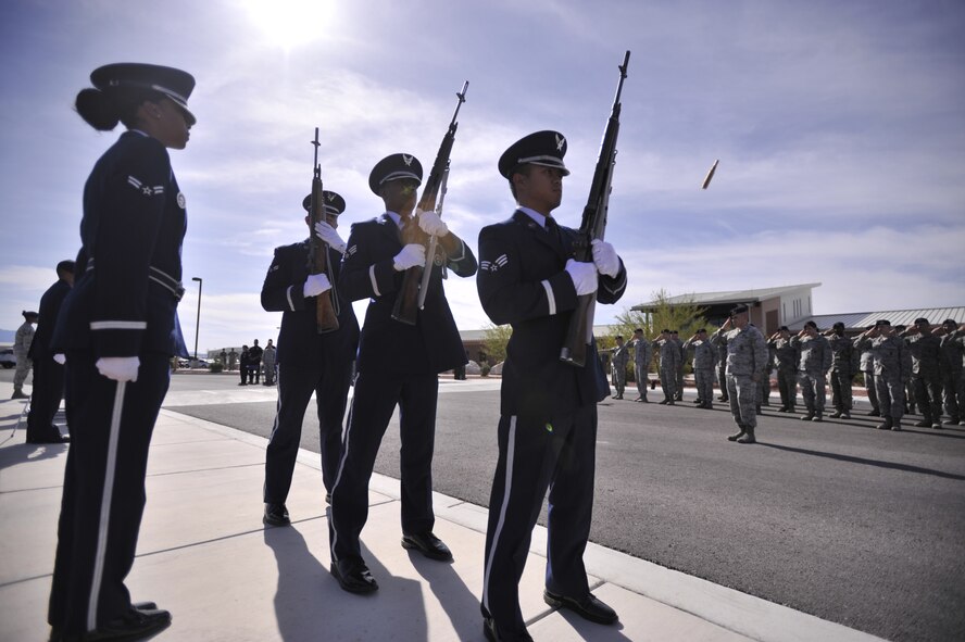 Members of the Nellis Air Force Base honor guard eject their brass while performing a 21 gun salute at a retreat ceremony May 15, 2016 at Creech Air Force Base, Nev. The ceremony took place during National Police Week which honors all the officers who have paid the ultimate sacrifice. (U.S. Air Force photo by Airman 1st Class C.C./Released)