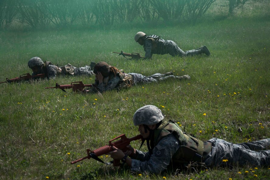 Members of the 5th Civil Engineer Squadron position themselves while scanning a field during an exercise on Minot Air Force Base, N.D., May 21, 2014. The exercise was part of a pre-deployment training session. (U.S. Air Force photo/Airman 1st Class Lauren Pitts) 