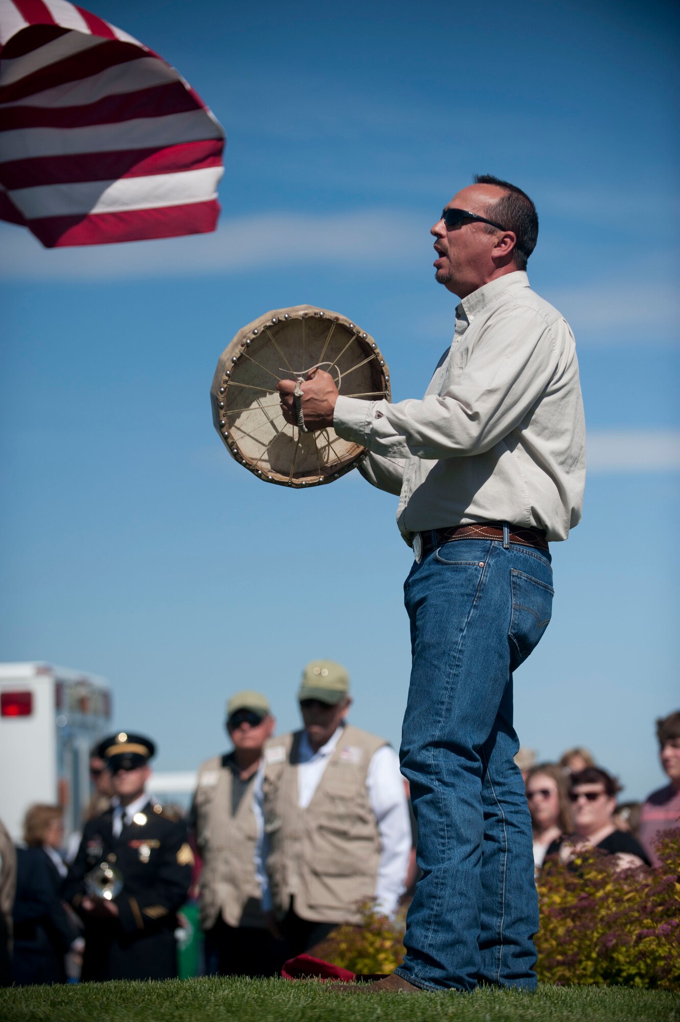 Cedric Decory, Native American Special Emphasis Manager, performs a Lakota Sioux tribute song during the Memorial Day Ceremony in Boise, May 26, 2014. During the ceremony, a fly-over tribute was performed by the Warhawk Air Museum. (U.S. Air Force photo by Airman 1st Class Malissa Lott/RELEASED)