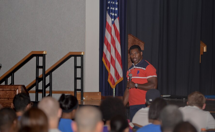 Herschel Walker, retired NFL player, speaks Team McConnell members during Wingman Day, May 22, 2014, at McConnell Air Force Base, Kan. During his speech, he talked about resiliency and how to apply it to day-to-day life. Wingman Day was an opportunity for members of Team McConnell to take a break from normal operations to maintain their resiliency. (U.S. Air Force photo/Airman 1st Class Colby L. Hardin)