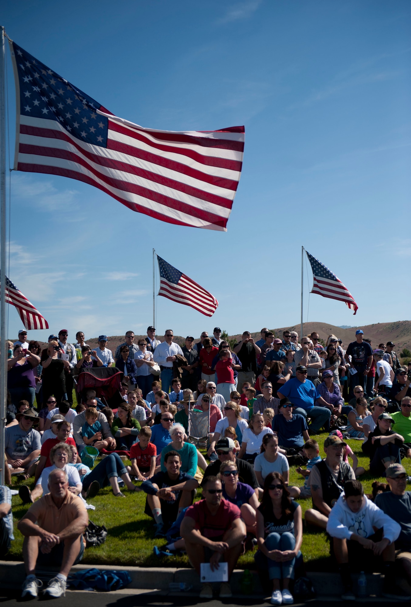 Guests watch as wreaths are laid in honor of past and present veterans during the Boise Memorial Day ceremony in Boise, Idaho, May 26, 2014. As part of the ceremony, cannons were fired by Idaho Military History Museum Civil War volunteers as a tribute to fallen service members. (U.S. Air Force photo by Airman 1st Class Malissa Lott/RELEASED)