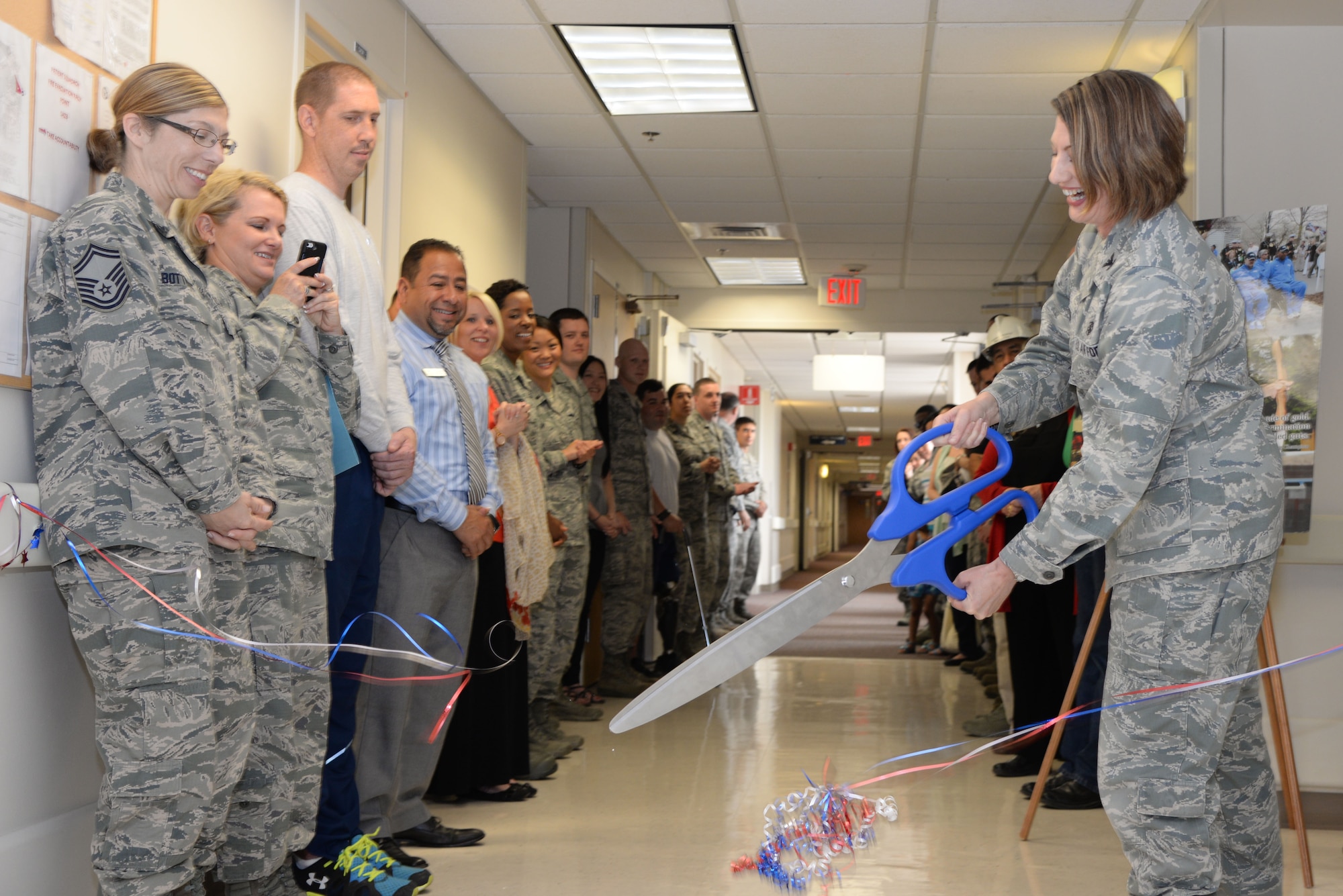Col. Heather Carter, 59th Medical Support Group commander, cuts a ceremonial ribbon officially designating the new home of the 59th Patient Squadron in the Wilford Hall Ambulatory Surgical Center, Joint Base San Antonio-Lackland, May 20, 2014. The Patient Squadron is dedicated to the treatment and rehabilitation of Airmen, wounded warriors, with complex medical conditions. (U.S. Air Force photo /Staff Sgt. Christopher Carwile)