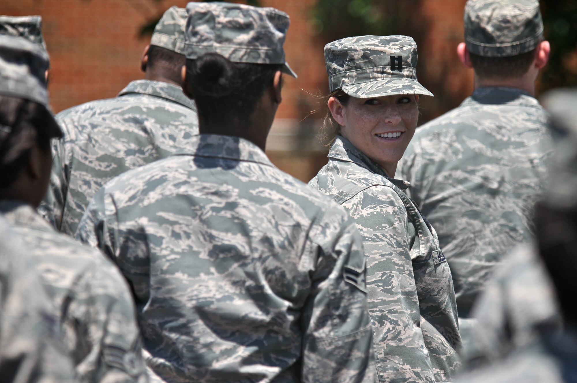 Capt. Jennifer Hellinger, with the Services Flight, Force Support Squadron (FSS), looks to see if she is about to be tapped and moved back as the the members of the FSS prepare for an open ranks inspection during the May Unit Training Assembly, May 18th on Scott Air Force Base. (U.S. Air Force photo by Tech. Sgt. Christopher Parr) 