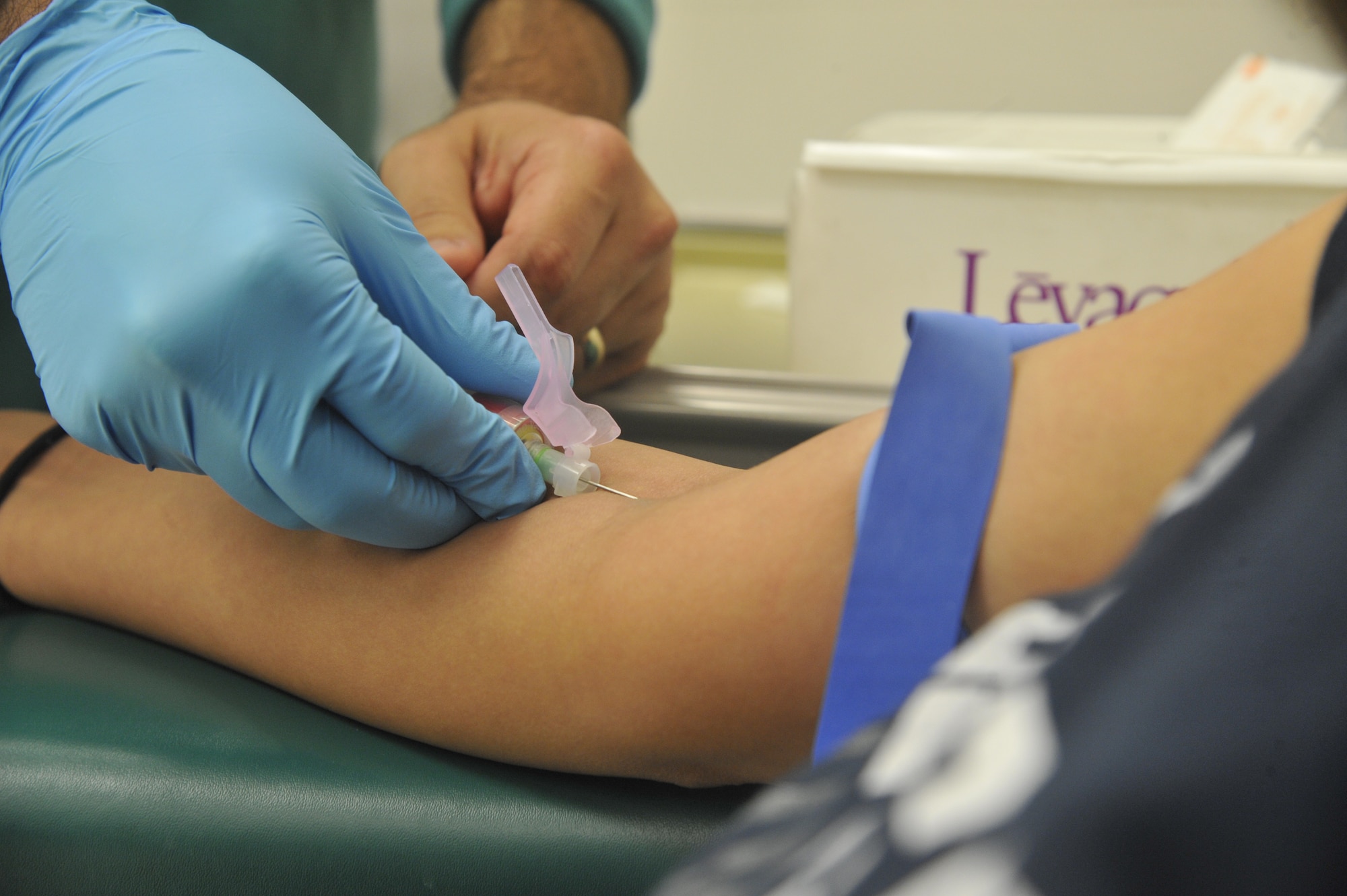 U.S. Air Force Tech. Sgt. Raul Loyo, 509th Medical Support Squadron NCO in charge of microbiology, collects blood sample from a patient at Whiteman Air Force Base, Mo., May 13, 2014. Samples collected are used to test for diseases and illnesses. (U.S. Air Force photo by Airman 1st Keenan Berry/Released)
